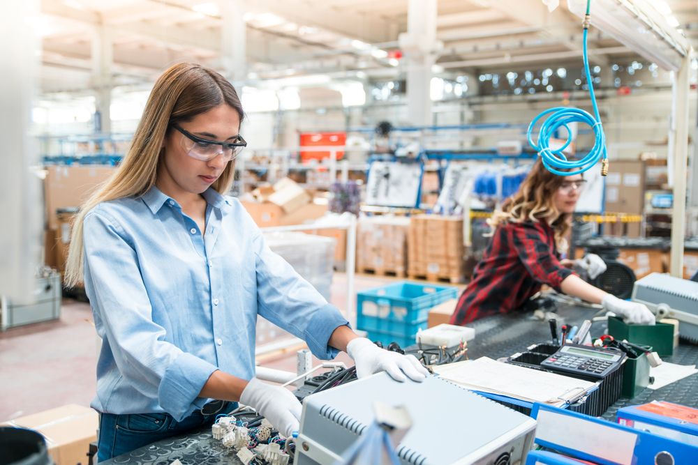 A girl doing her work while wearing safety glasses